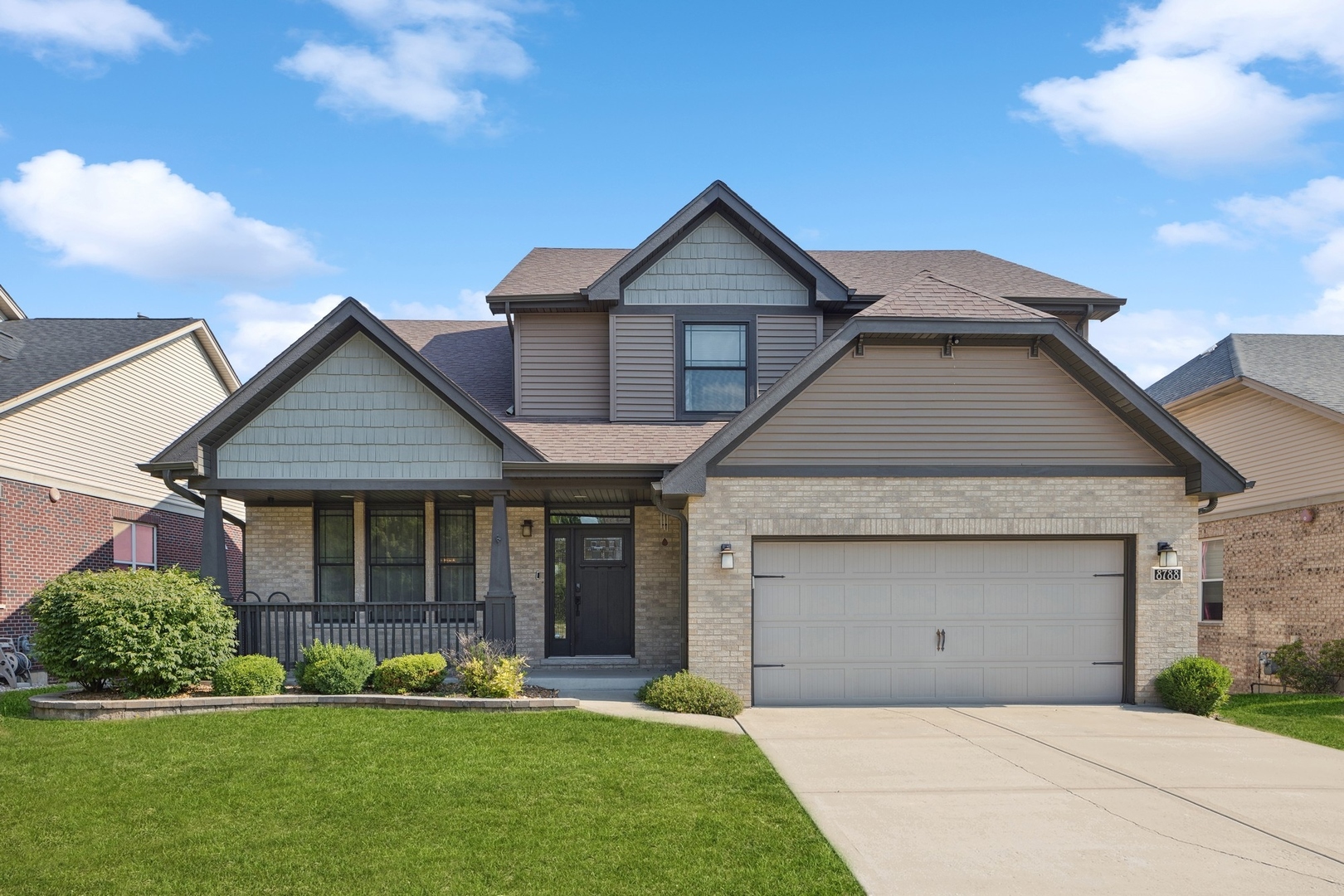 a front view of a house with a yard and garage