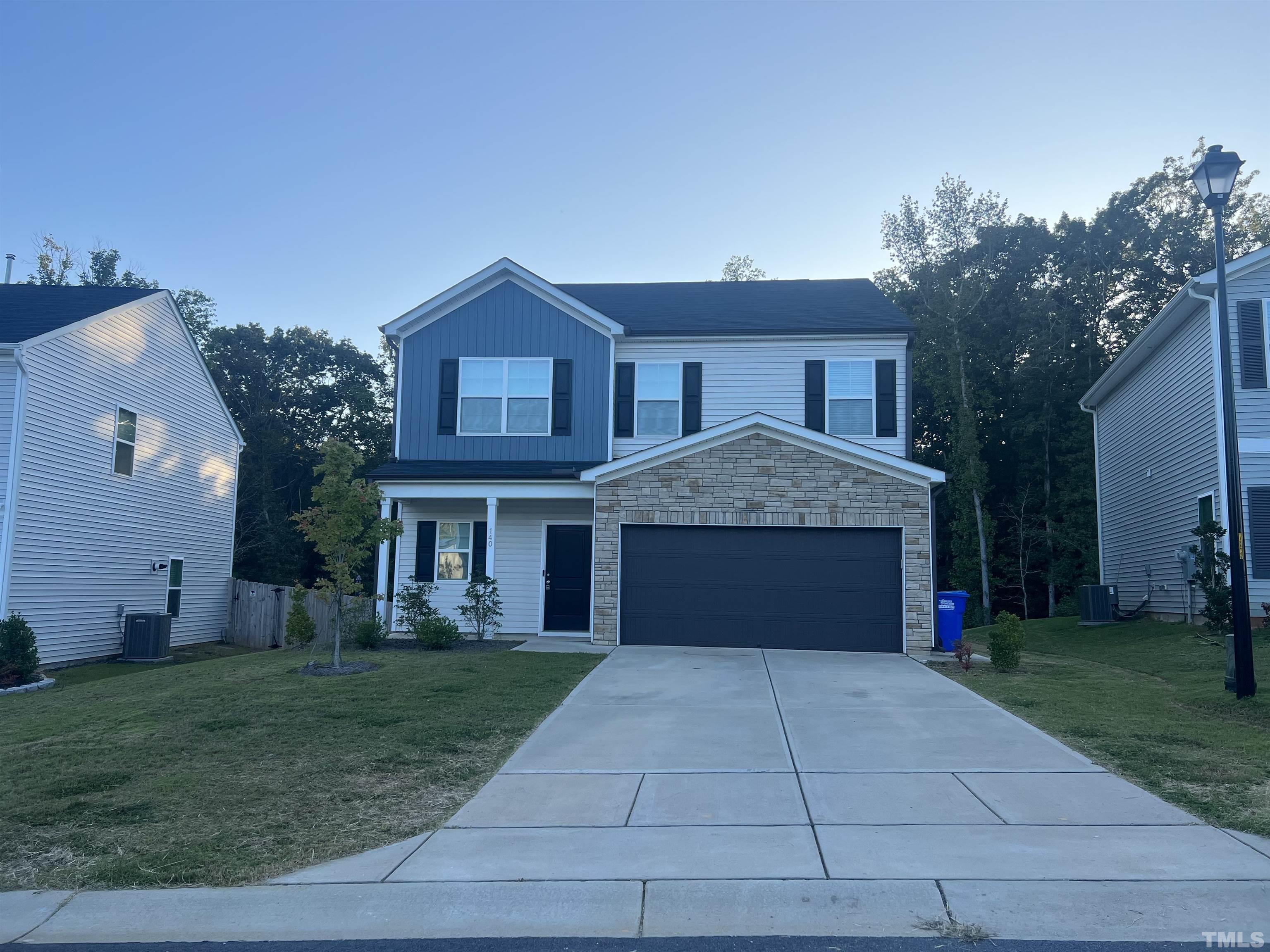 a front view of house with yard garage and green space