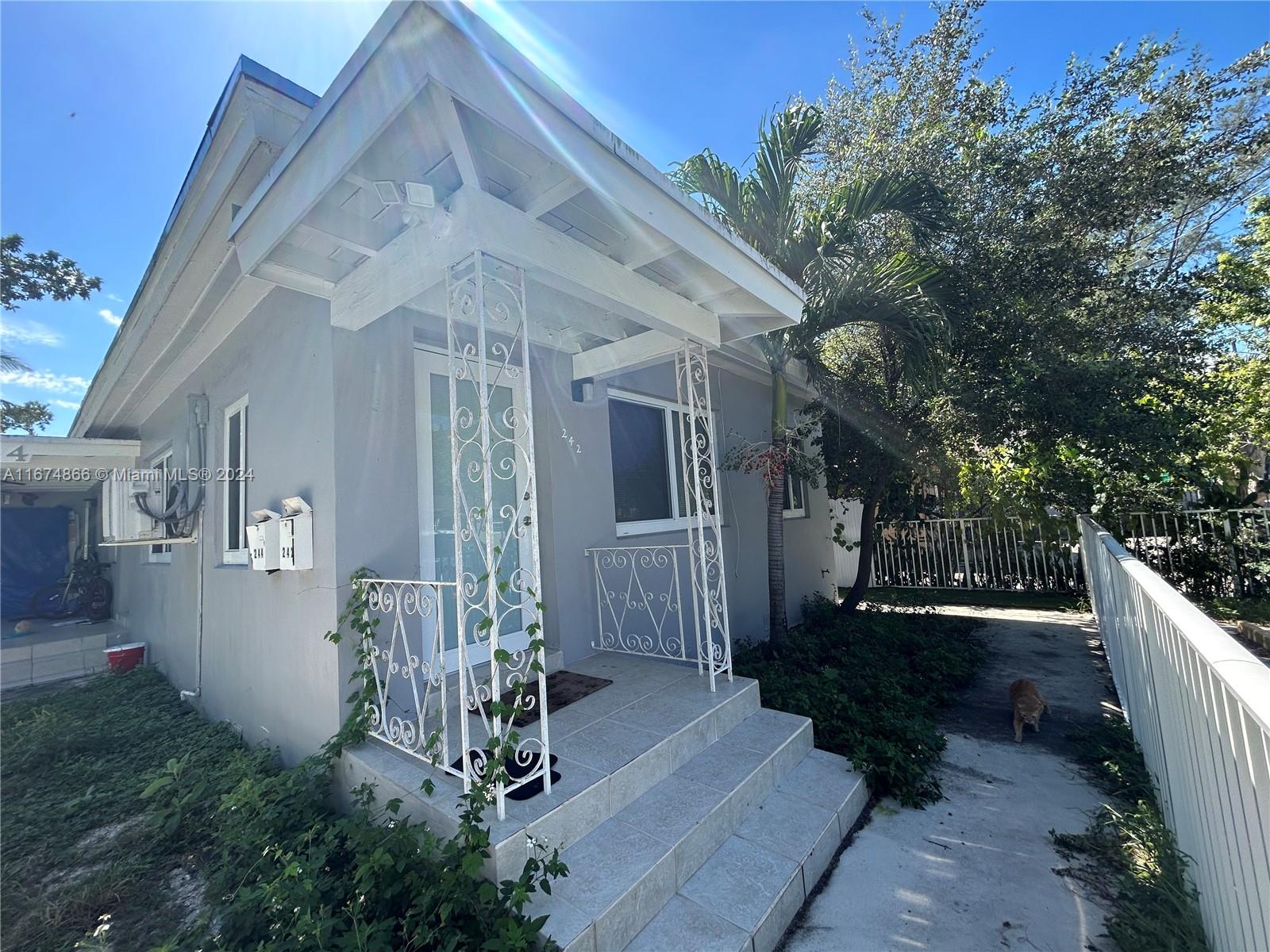 a view of house with backyard and glass door