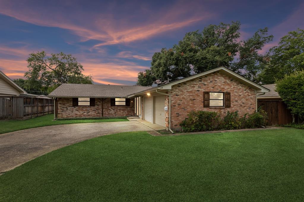 a front view of a house with a yard and pathway