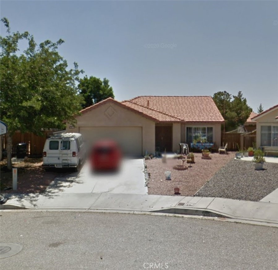 a view of a house with a patio and sitting area