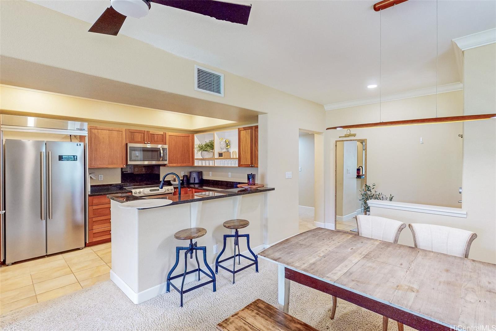 a kitchen with stainless steel appliances granite countertop a sink and a refrigerator