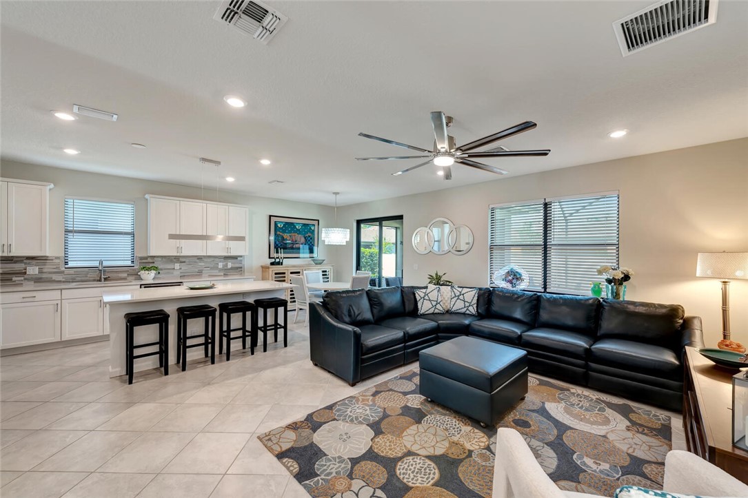 a living room with furniture and kitchen view