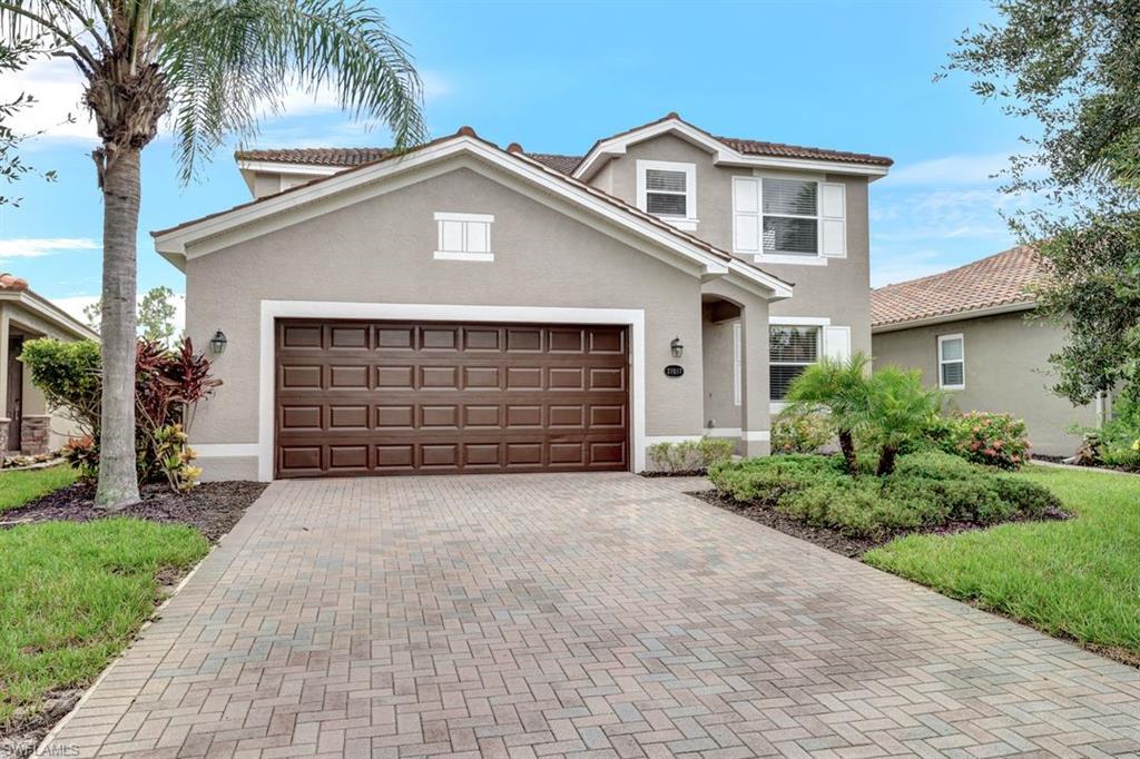 a front view of a house with a garden and garage