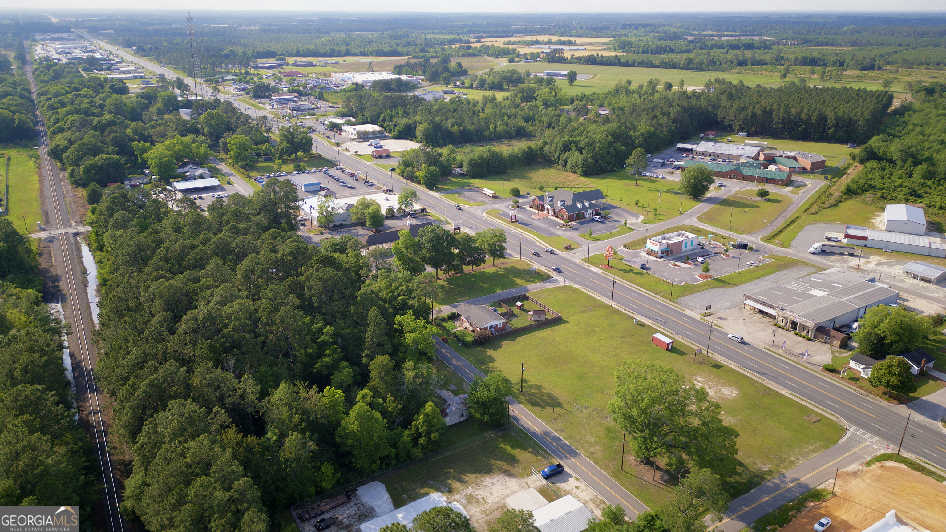 an aerial view of lake residential houses with outdoor space and swimming pool