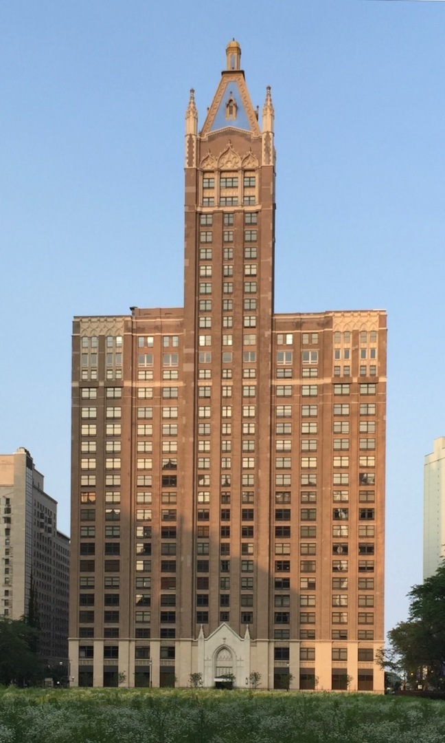 a front view of a building with a garden