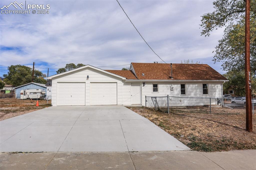 a view of a house with a yard and garage