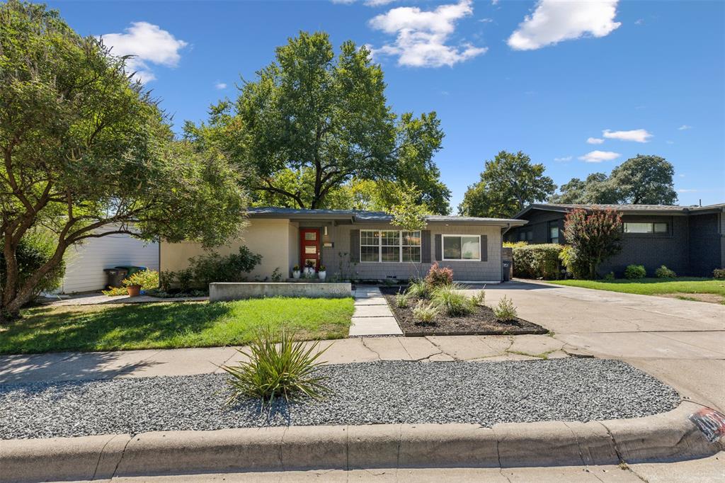 a view of a house with a yard and tree s