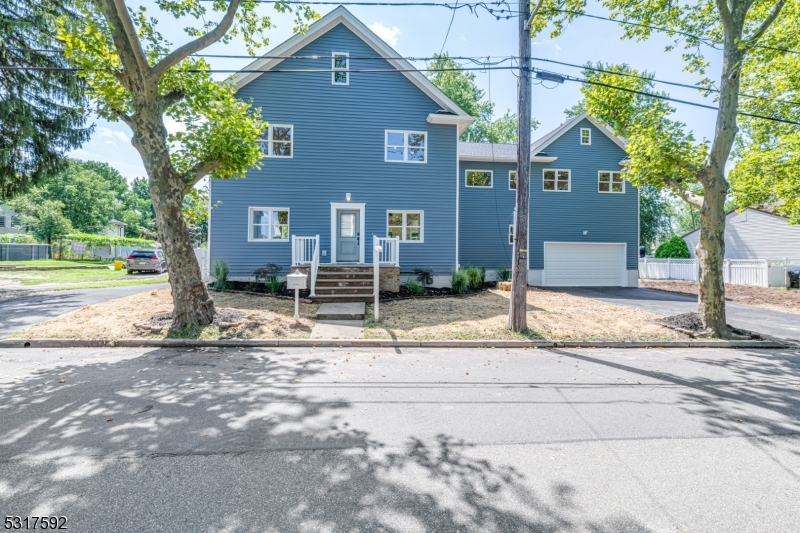 a house that has a tree in front of it