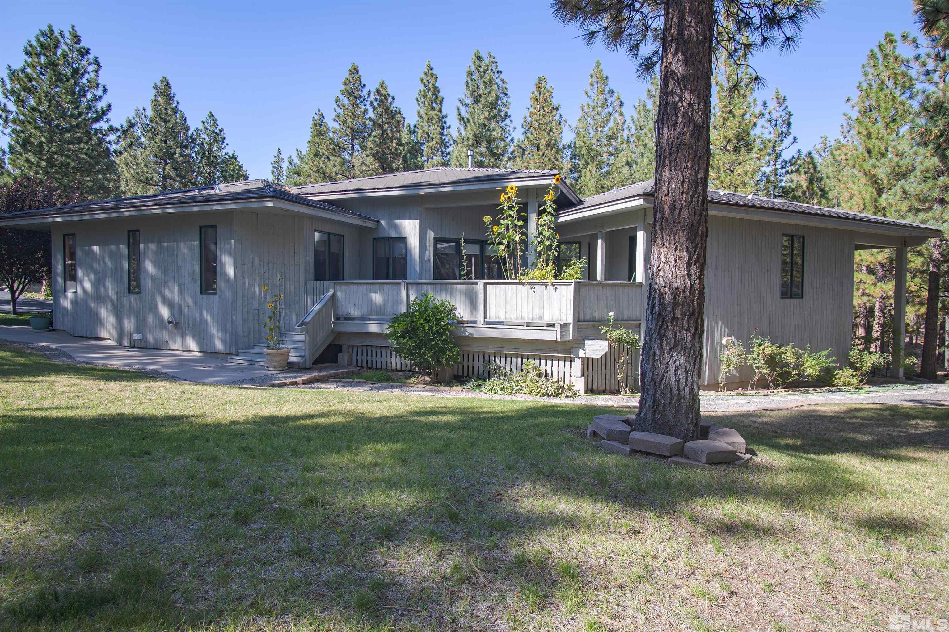 a front view of house with a garden