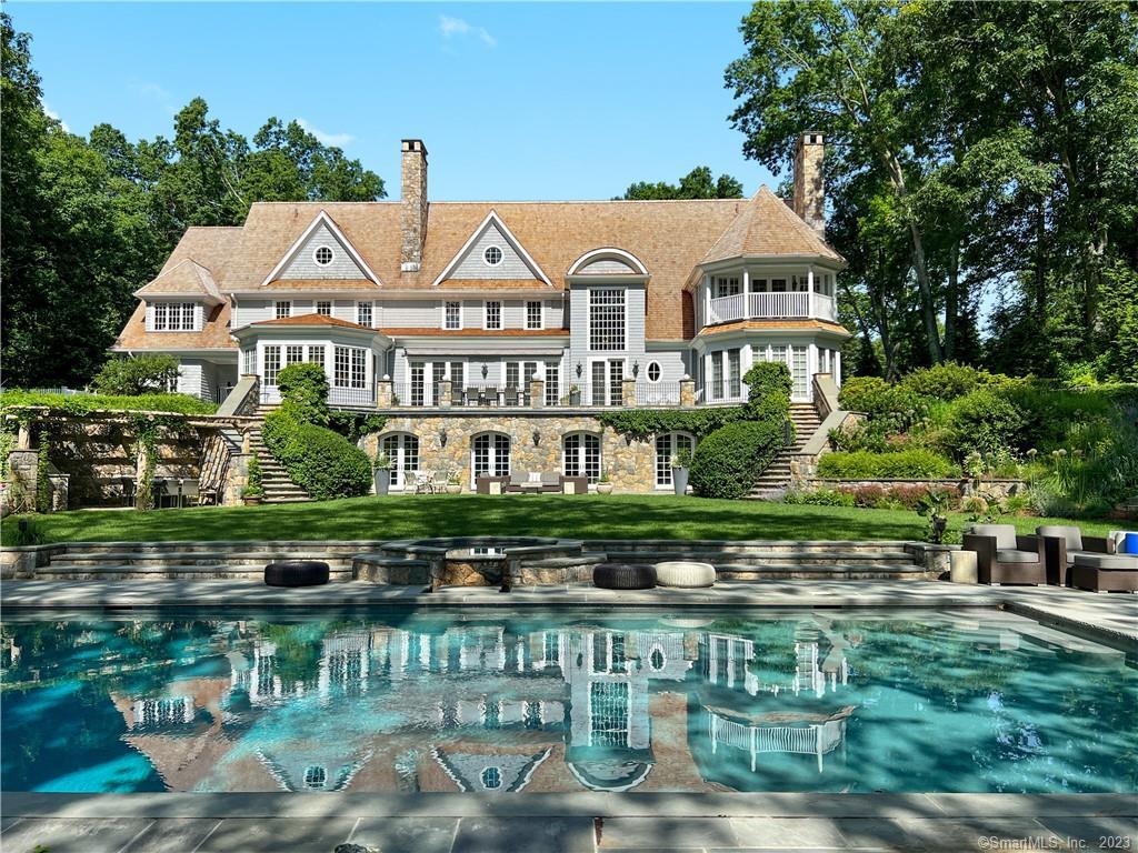 a aerial view of a house with lake view and a fountain