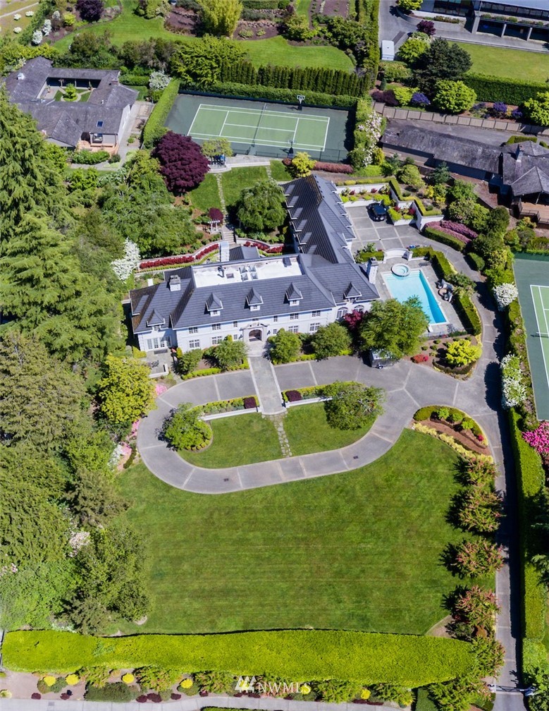 an aerial view of residential houses with outdoor space and parking