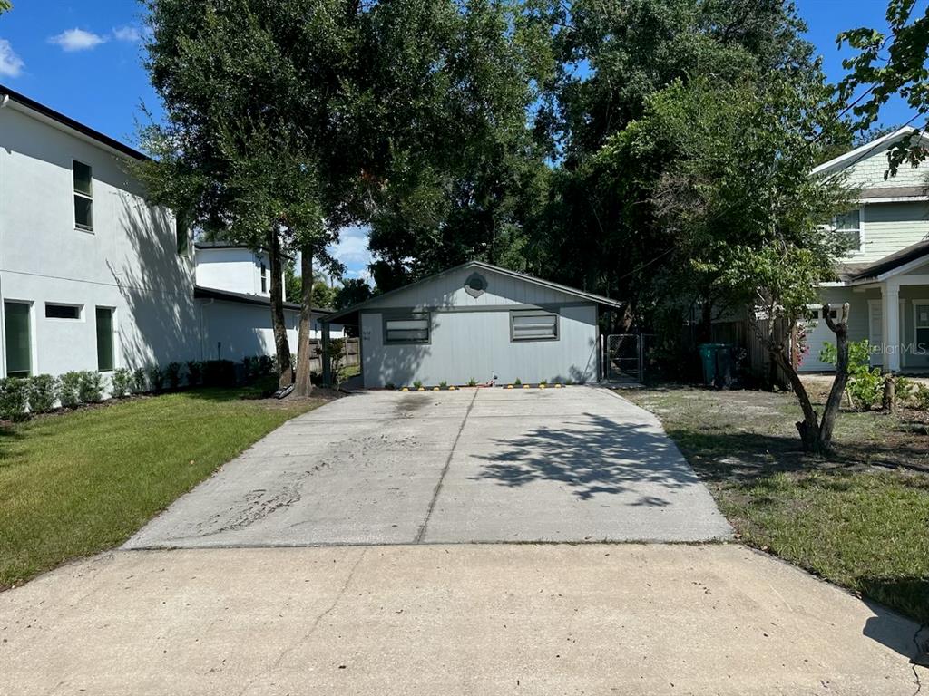 a view of a grey house with a yard