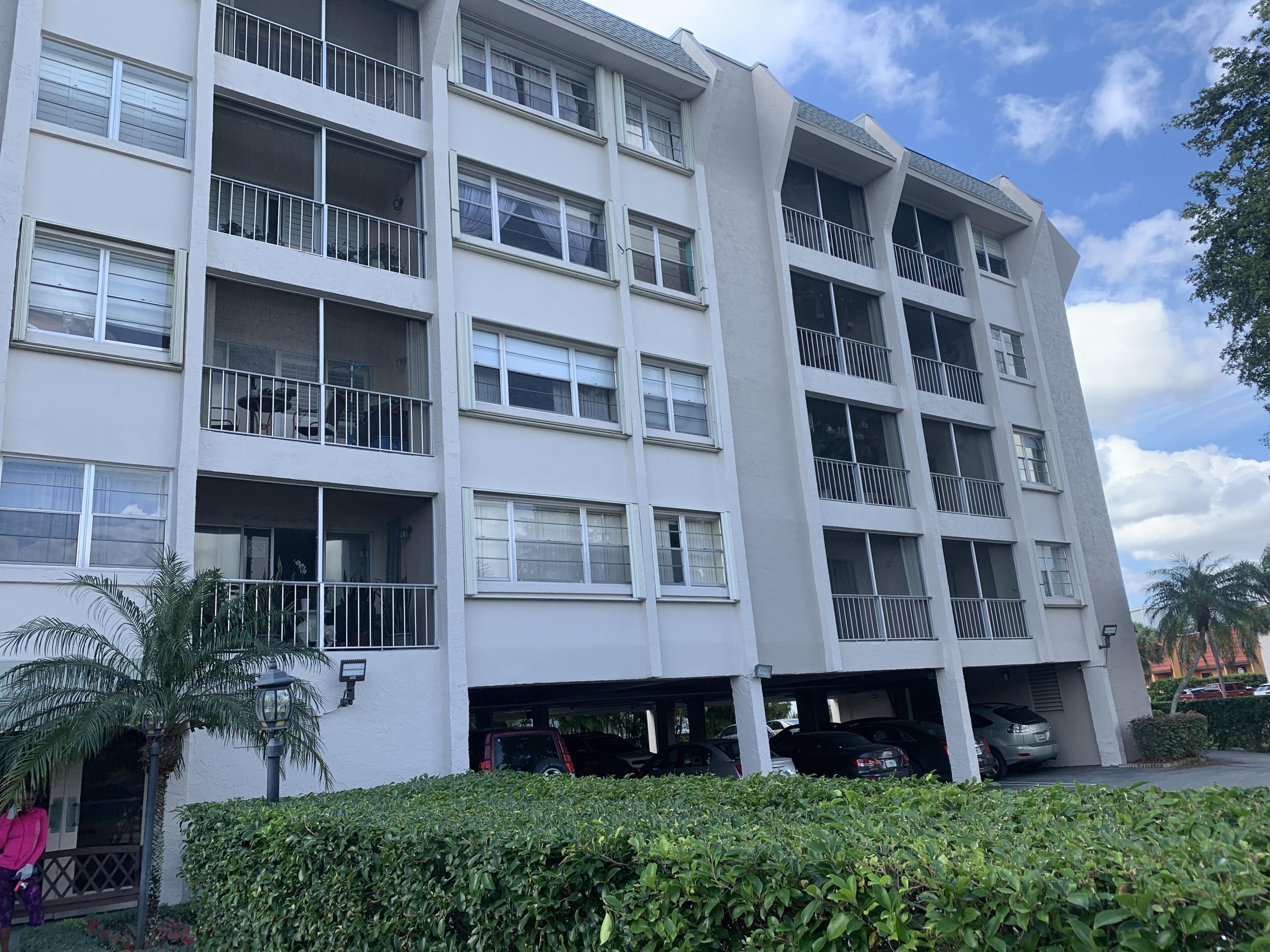 a view of an apartment with a large windows and a yard