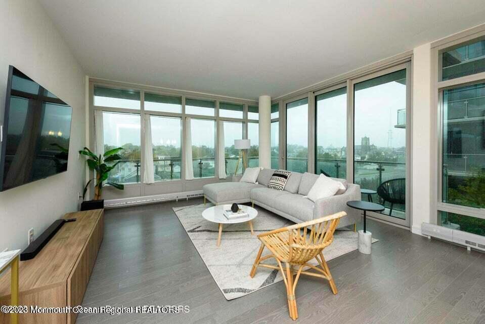 a dining room with furniture and large windows