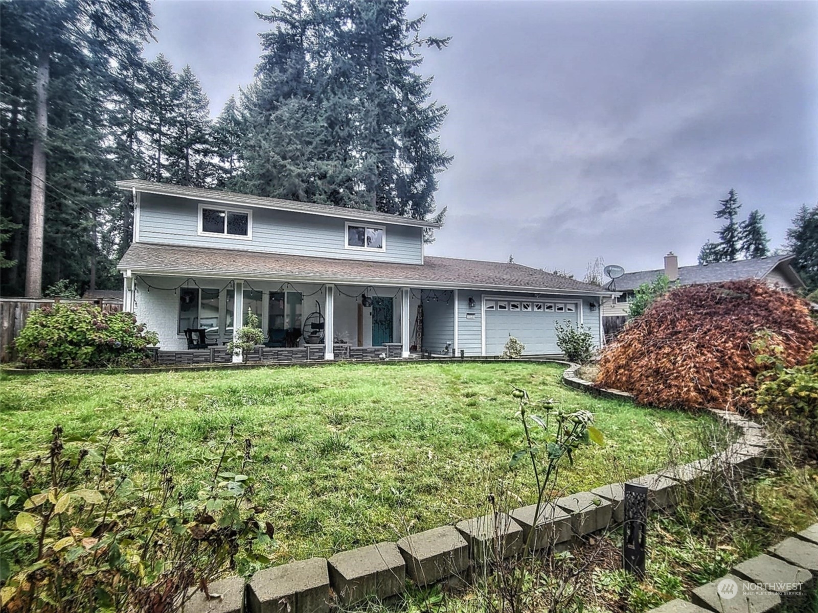 a front view of a house with a garden