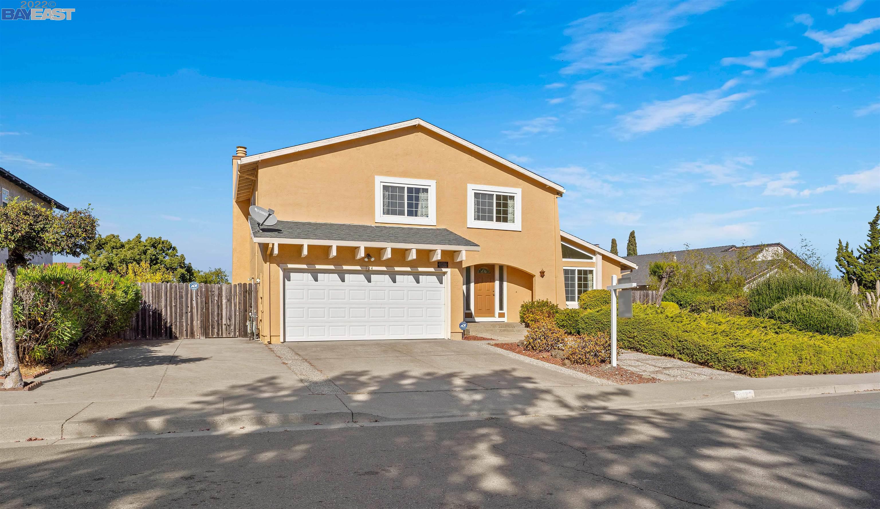 a view of a house with a yard and garage