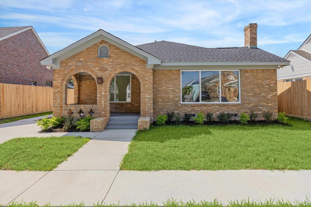 Front fascia view with beautiful brick walls, new double-pane windows, and new roof