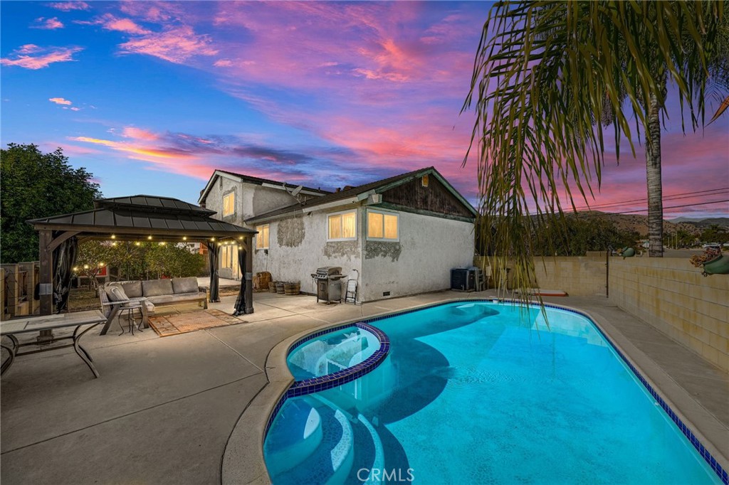 a swimming pool with outdoor seating and yard