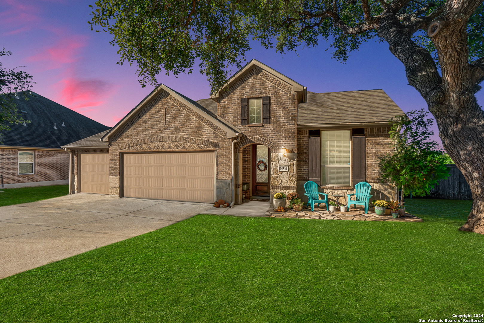 a front view of a house with a garden and yard