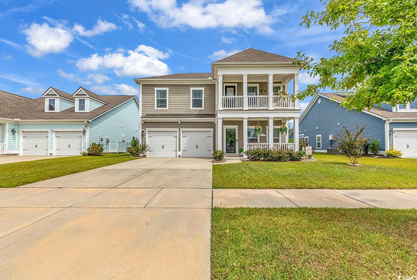 View of front of property featuring a garage, a fr