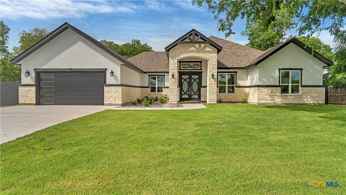 a front view of house with yard and green space