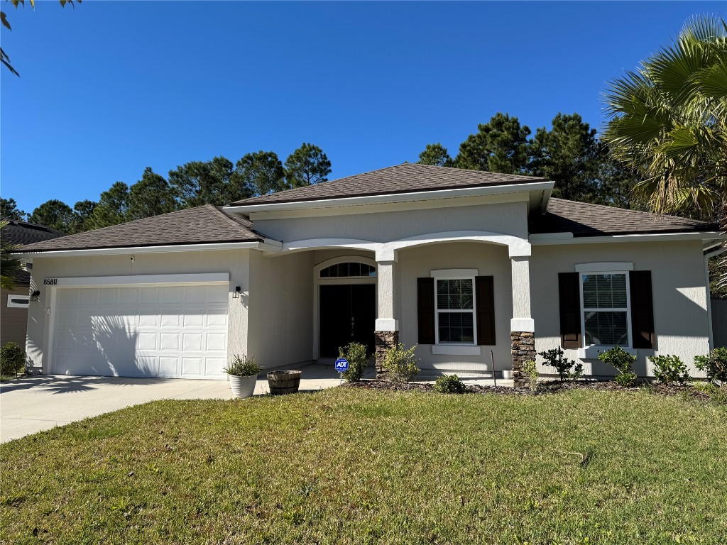 a view of a house with backyard and porch