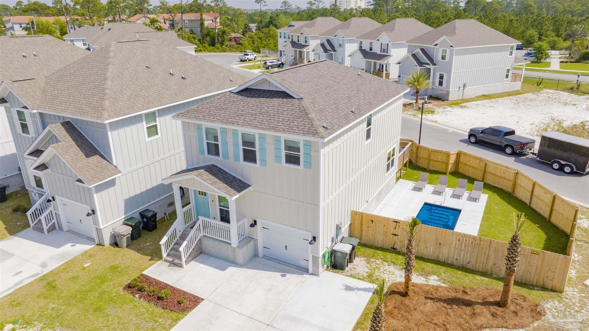 an aerial view of residential houses with outdoor space