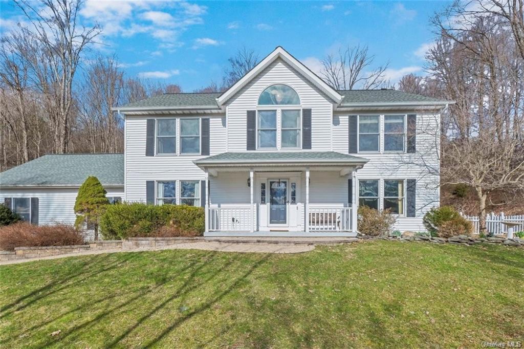 View of front of house with a front lawn and a porch