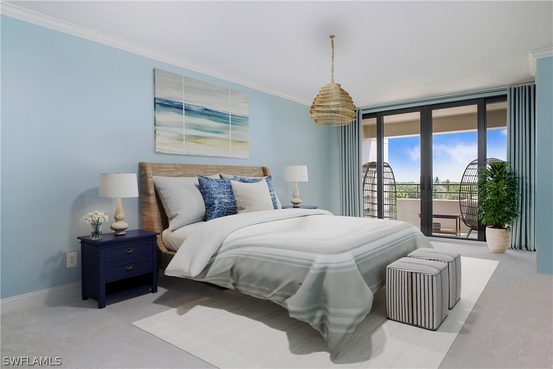 a bedroom with a large bed and a chandelier