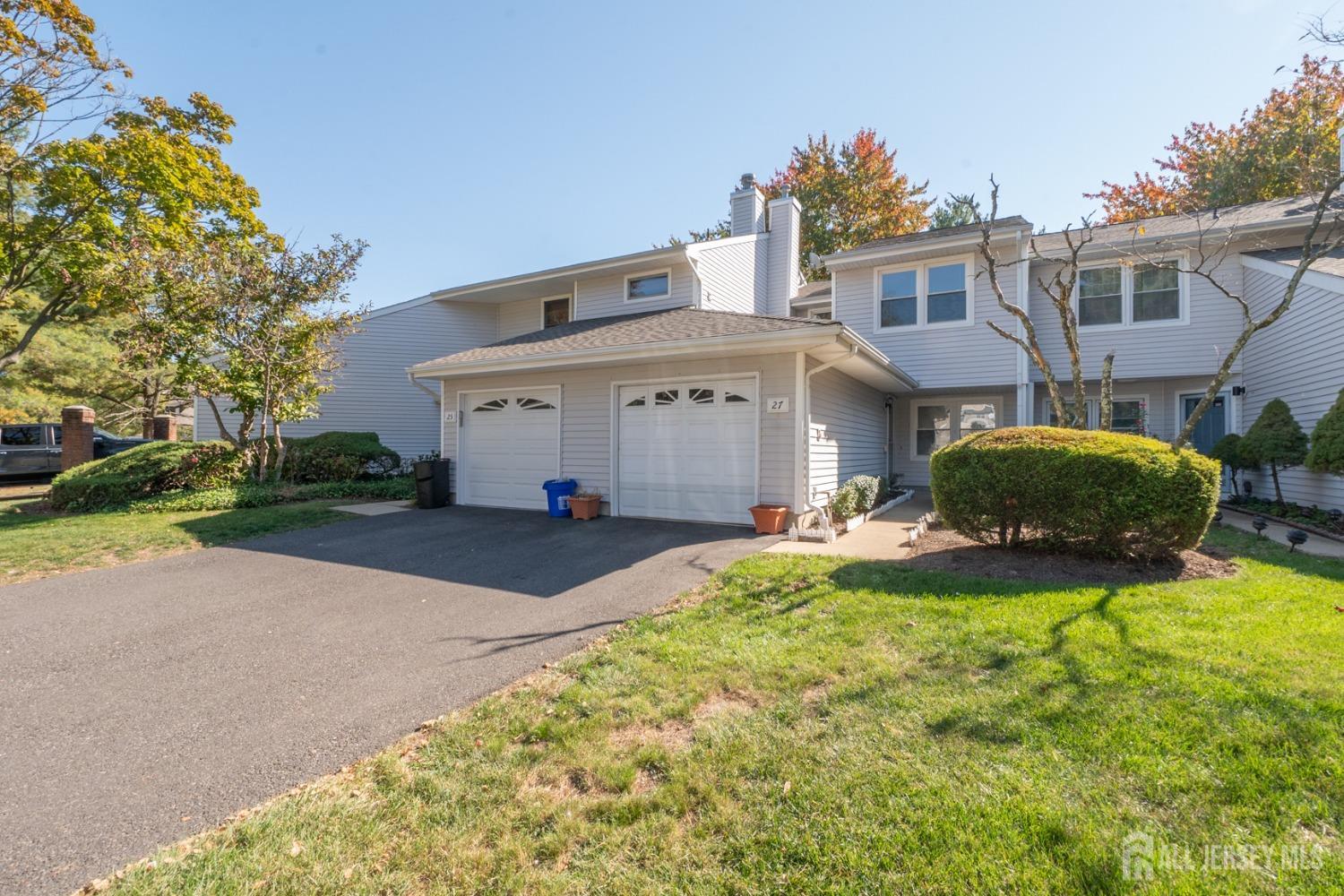 a view of house with yard and outdoor seating