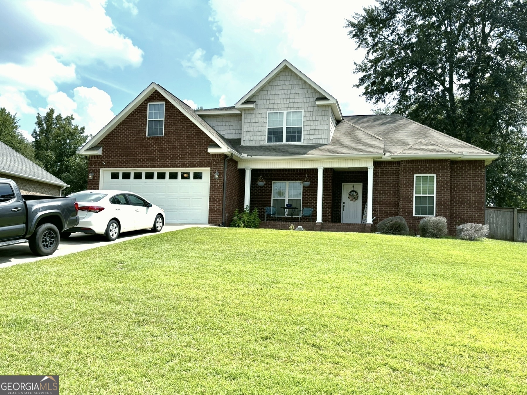 a front view of a house with a garden