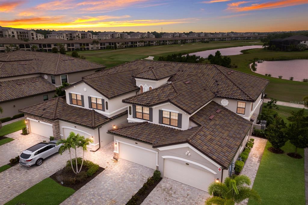 an aerial view of multiple houses with a yard