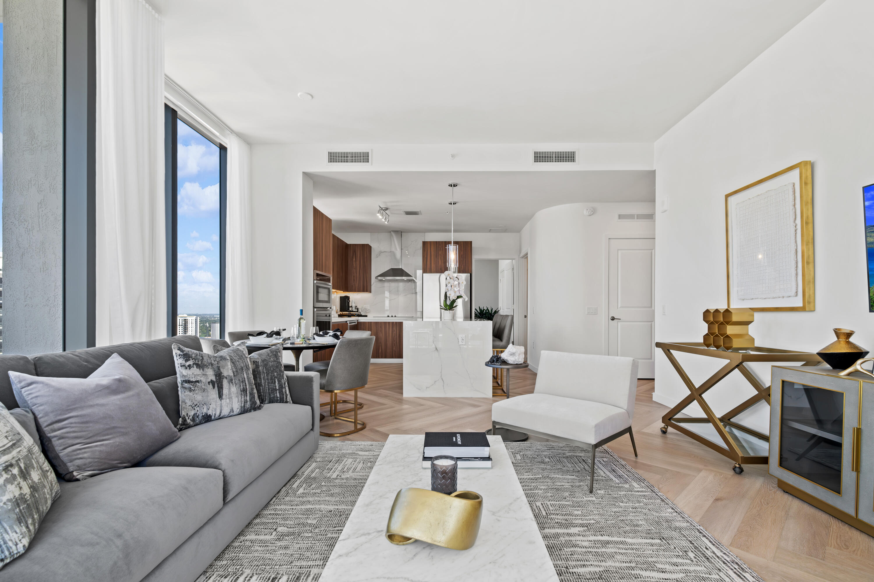 a living room with furniture and wooden floor