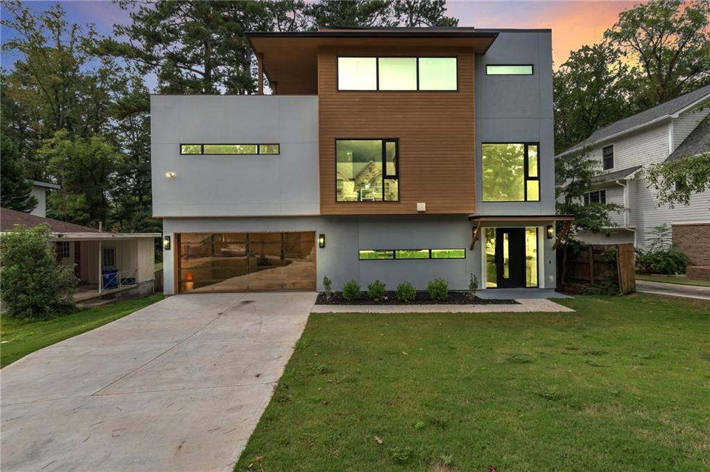 a view of a house with a yard and garage