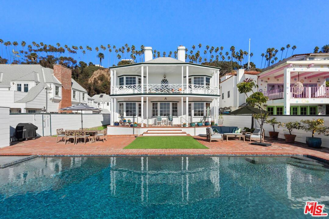 a view of a house with swimming pool yard and sitting area