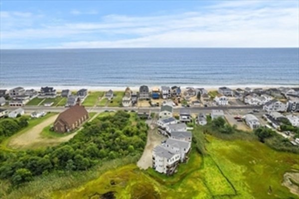 an aerial view of residential building and ocean