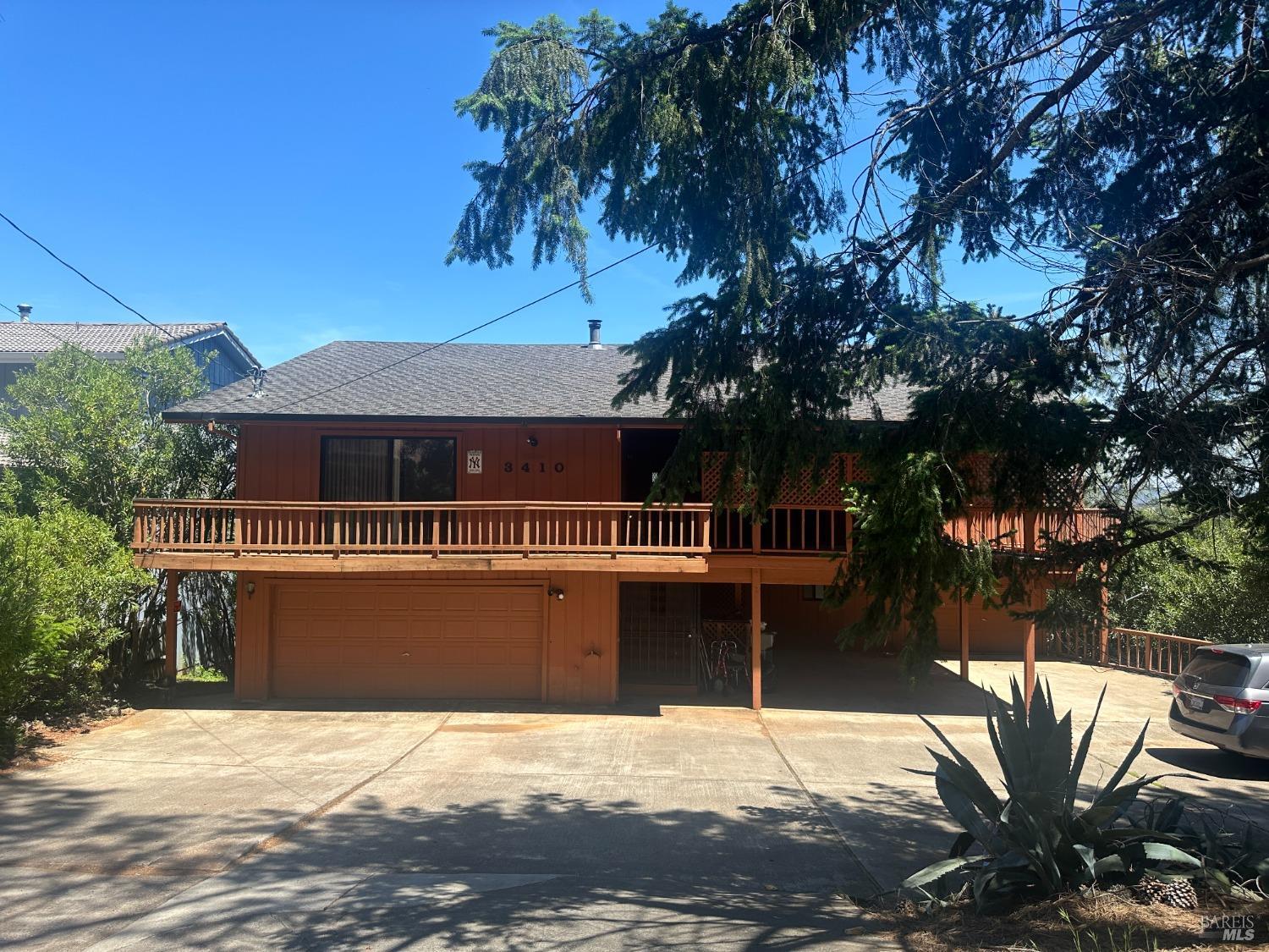 a view of house with backyard and seating space