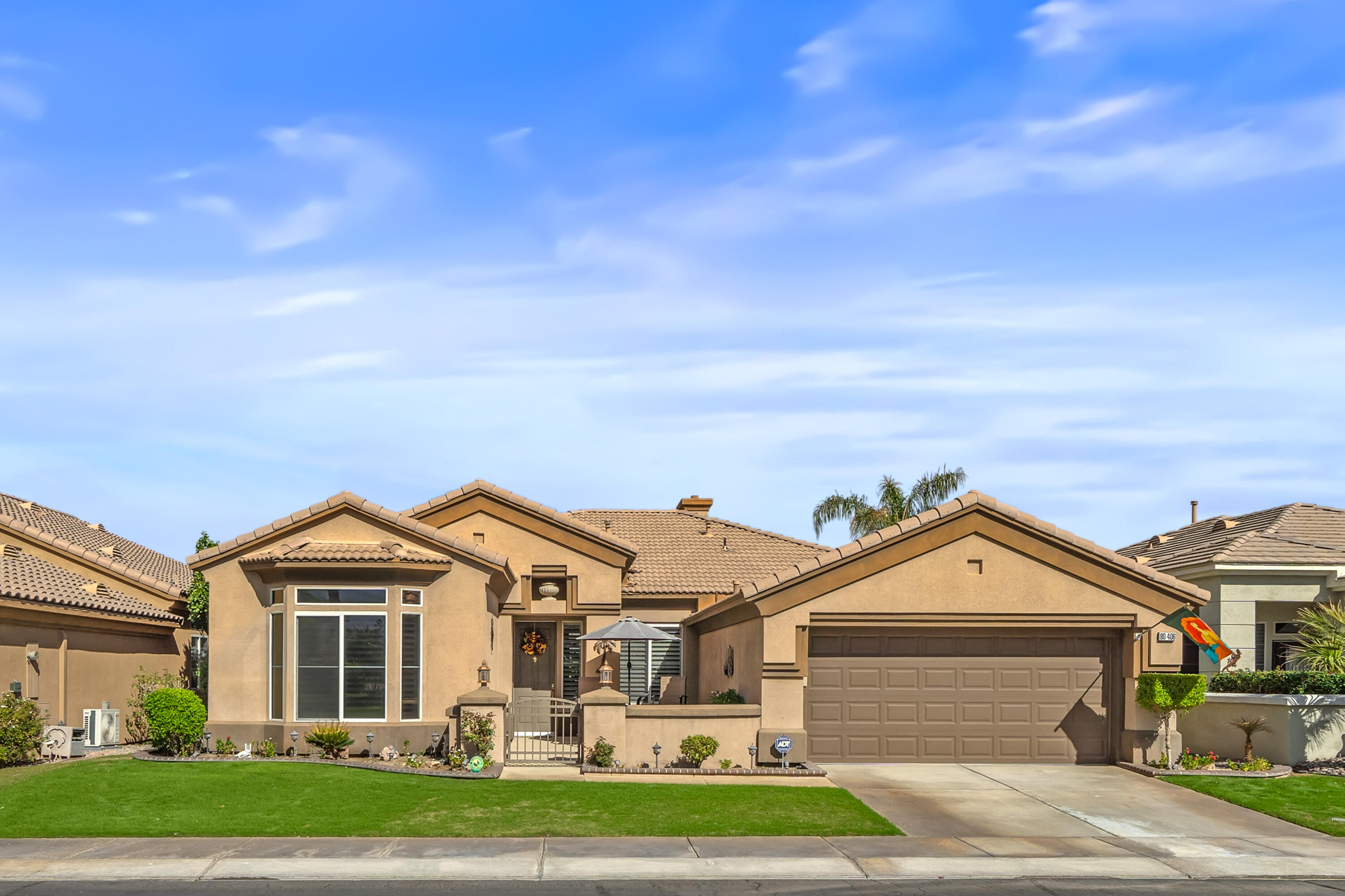 a front view of a house with a garden and yard