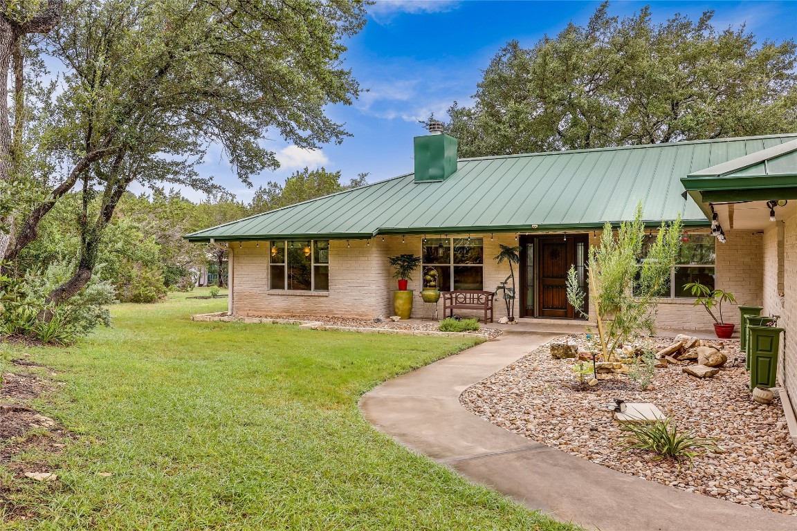 a front view of a house with a garden and patio