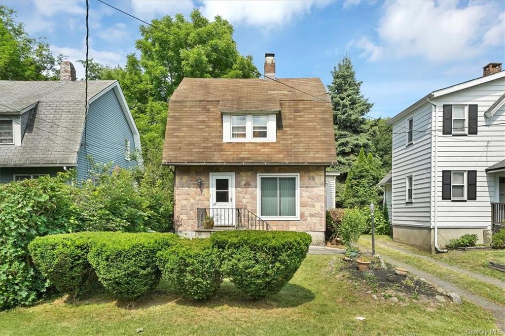 front view of a house with a yard