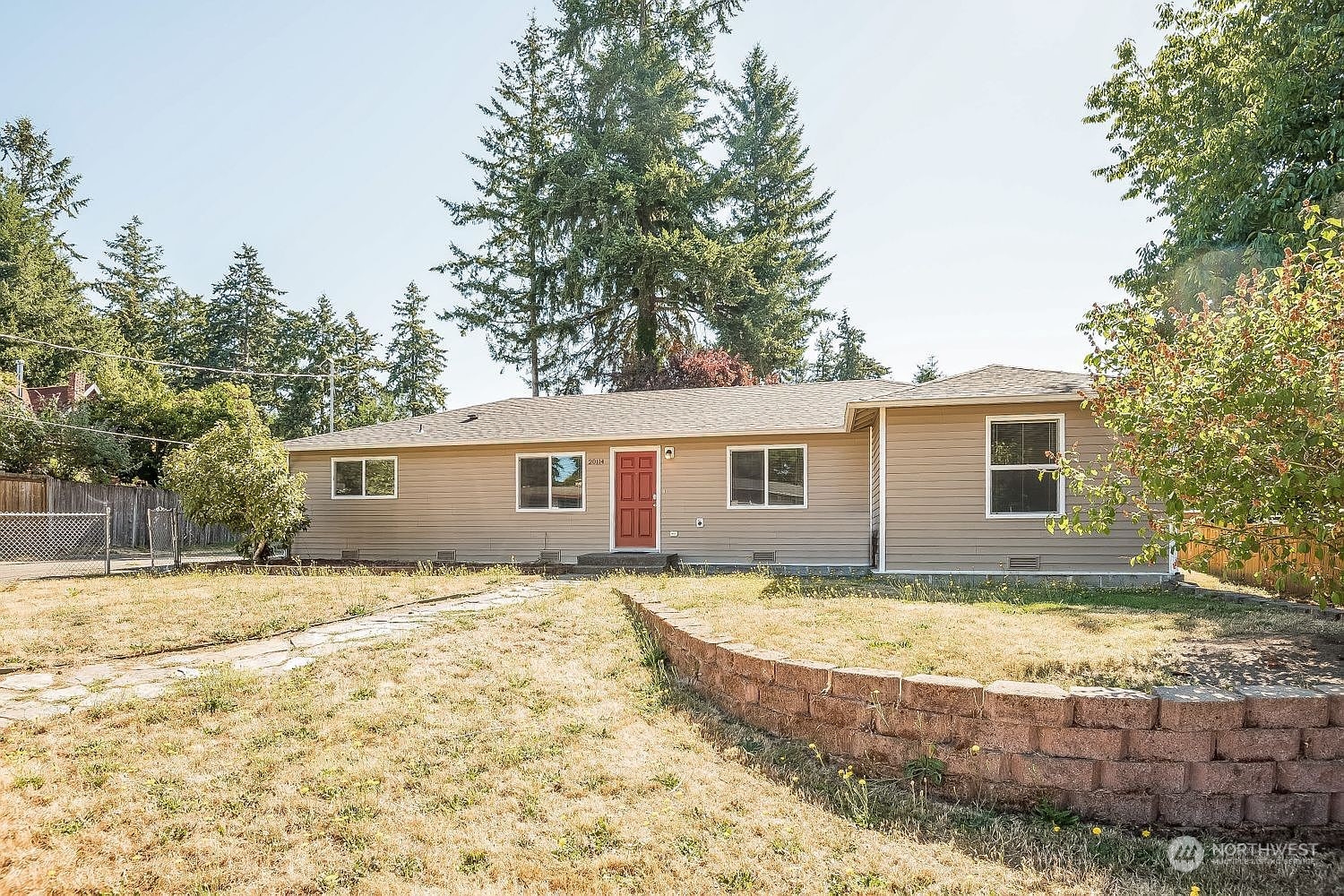 a view of a house with a backyard