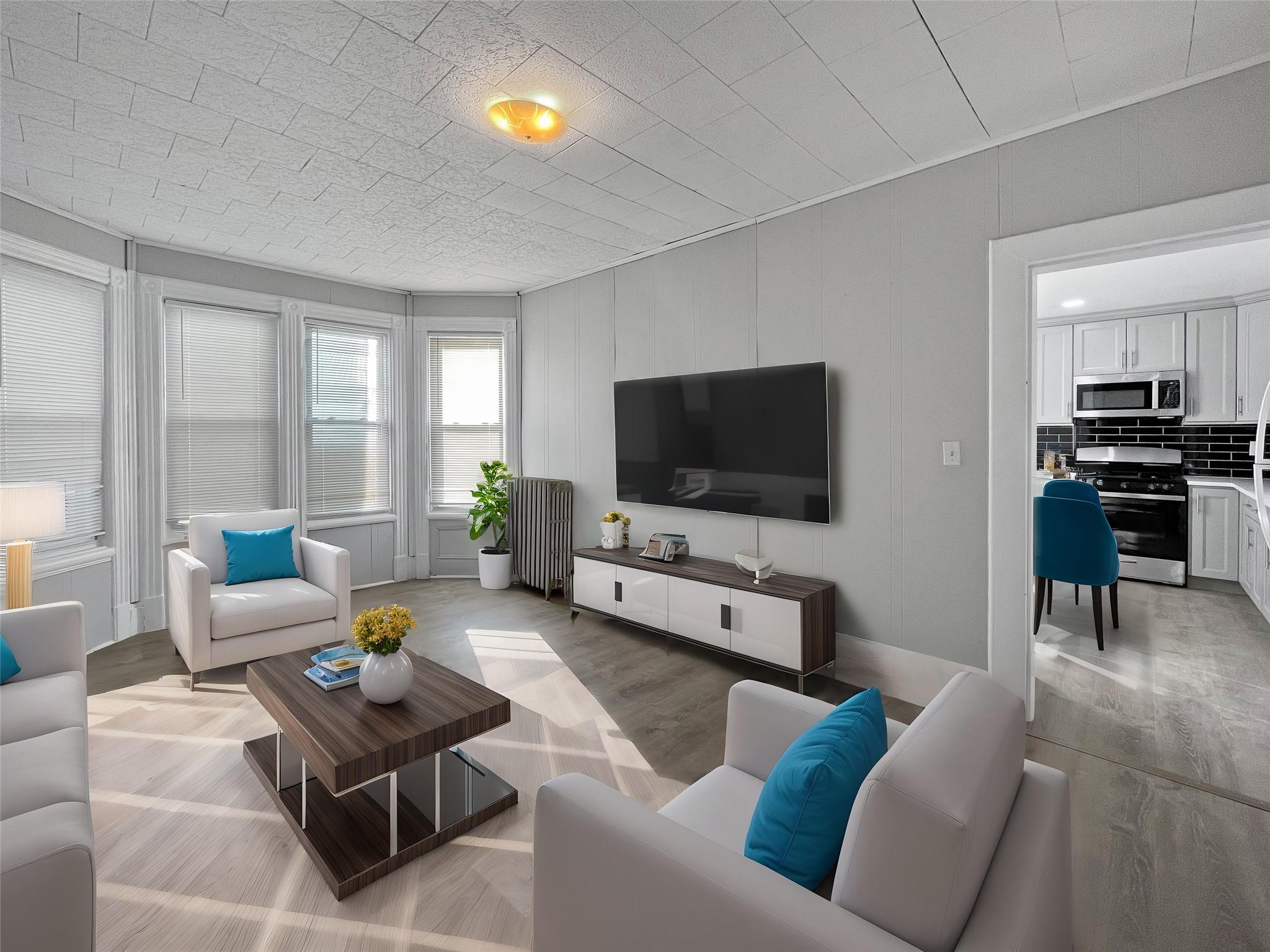 Living room featuring light wood-type flooring and radiator heating unit