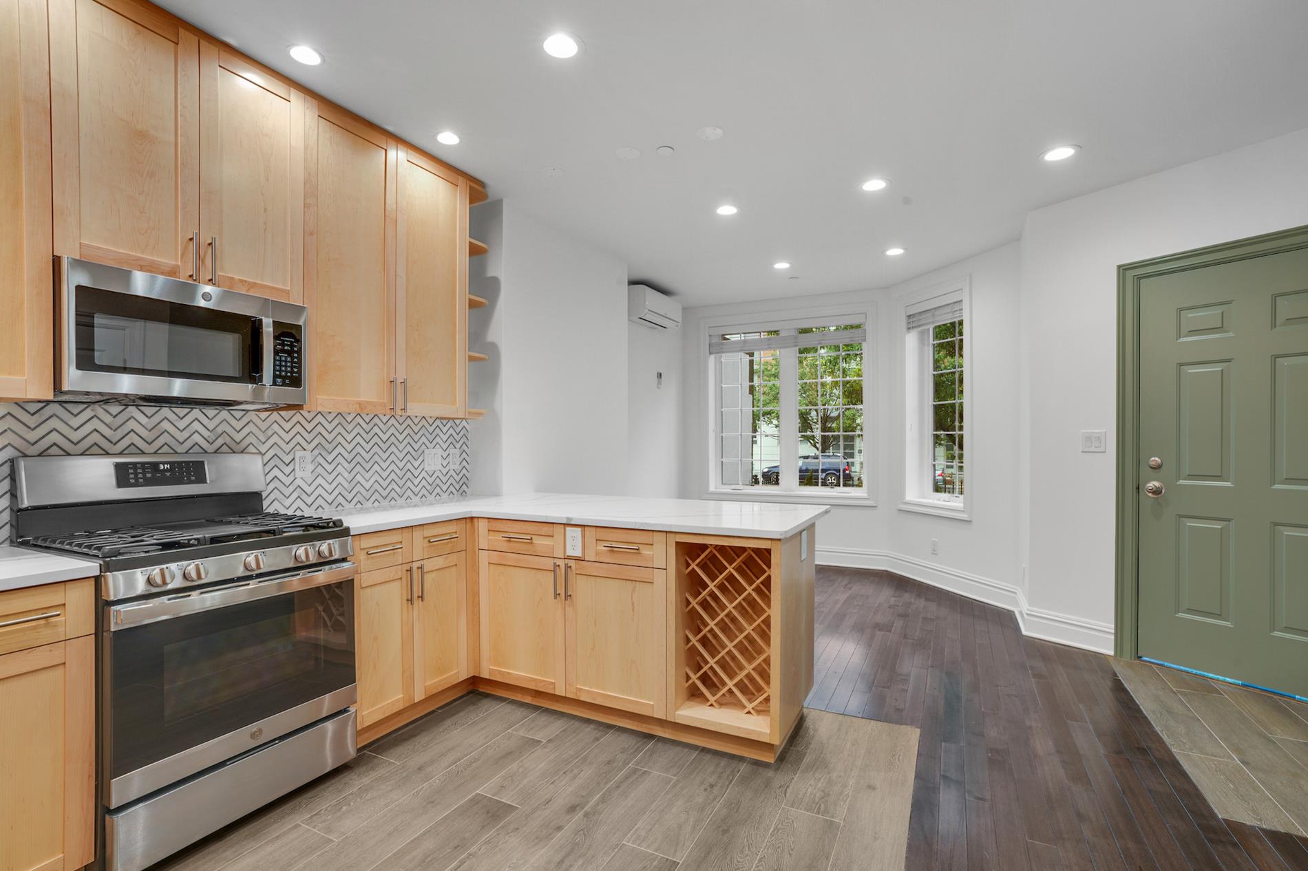 a kitchen with stainless steel appliances granite countertop wooden cabinets and a stove top oven