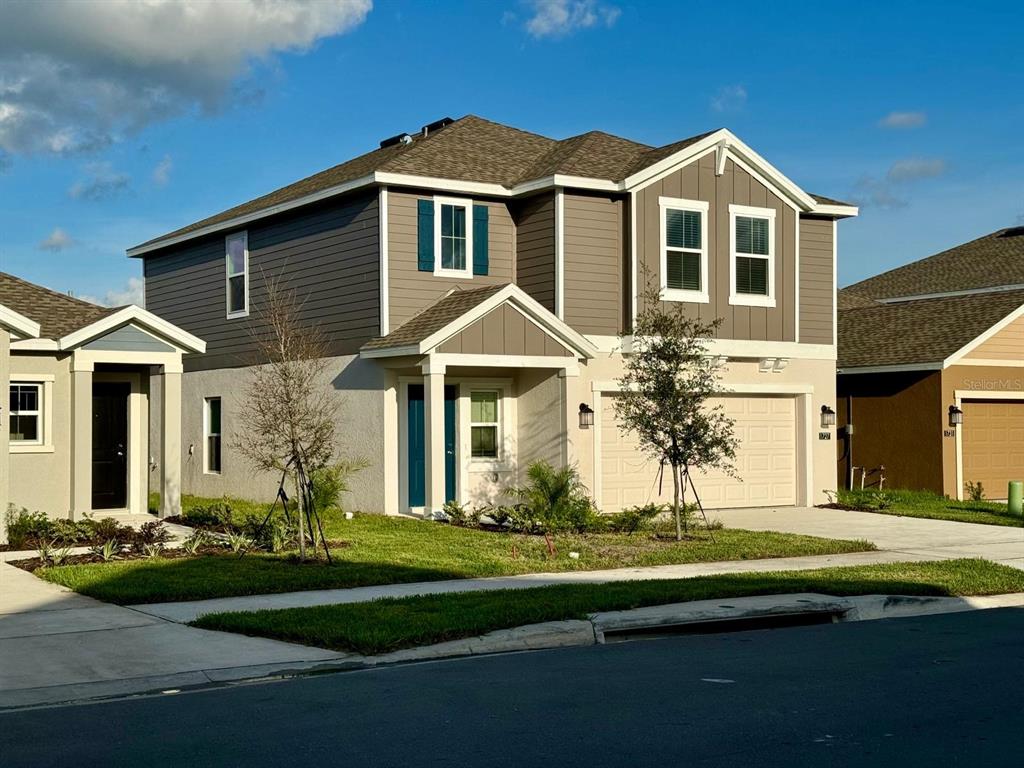 a front view of a house with a yard and garage