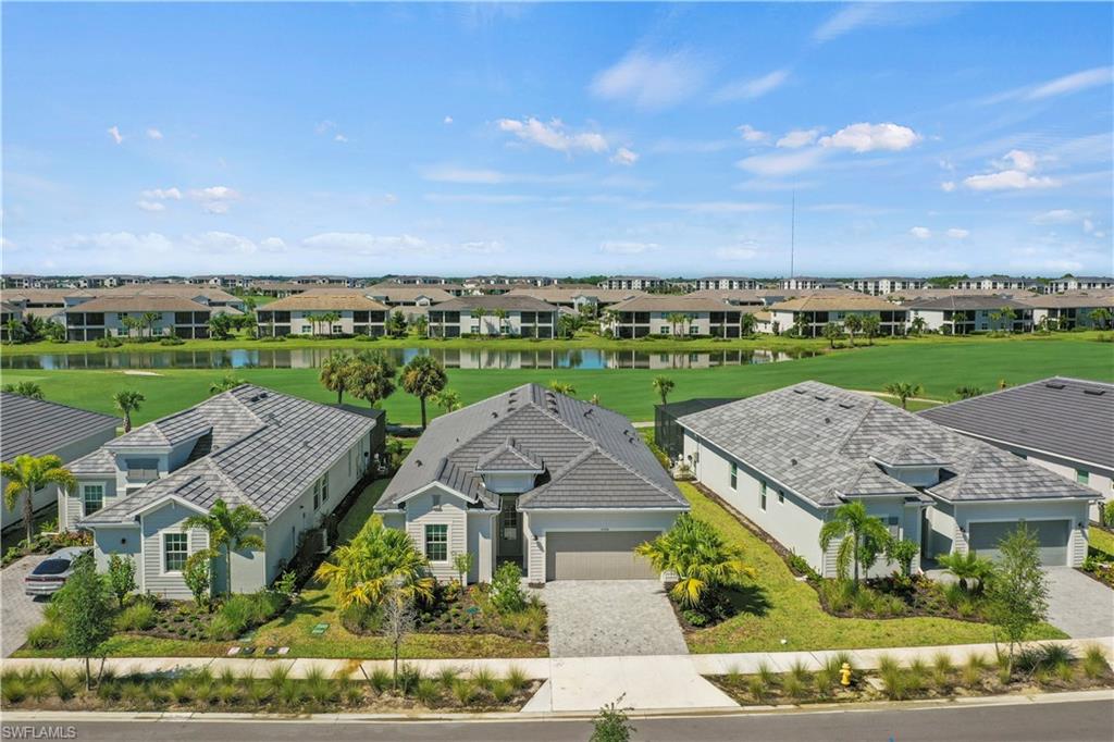 an aerial view of a house with a garden and lake view