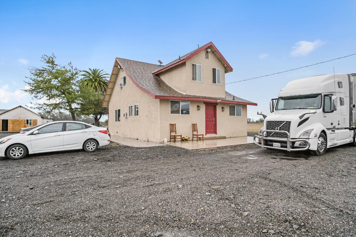 a view of a house with car parked