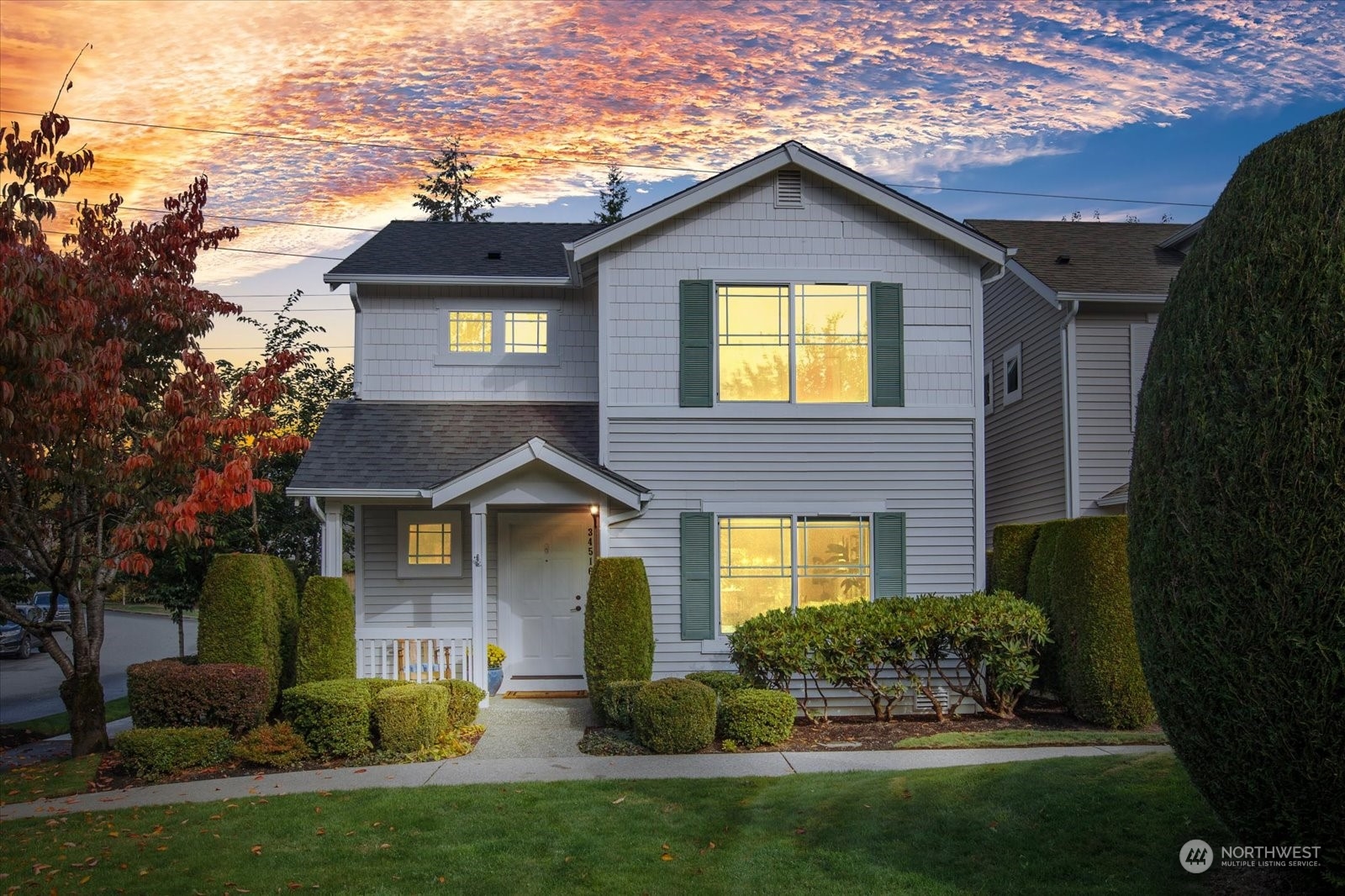 a front view of a house with a yard and outdoor seating