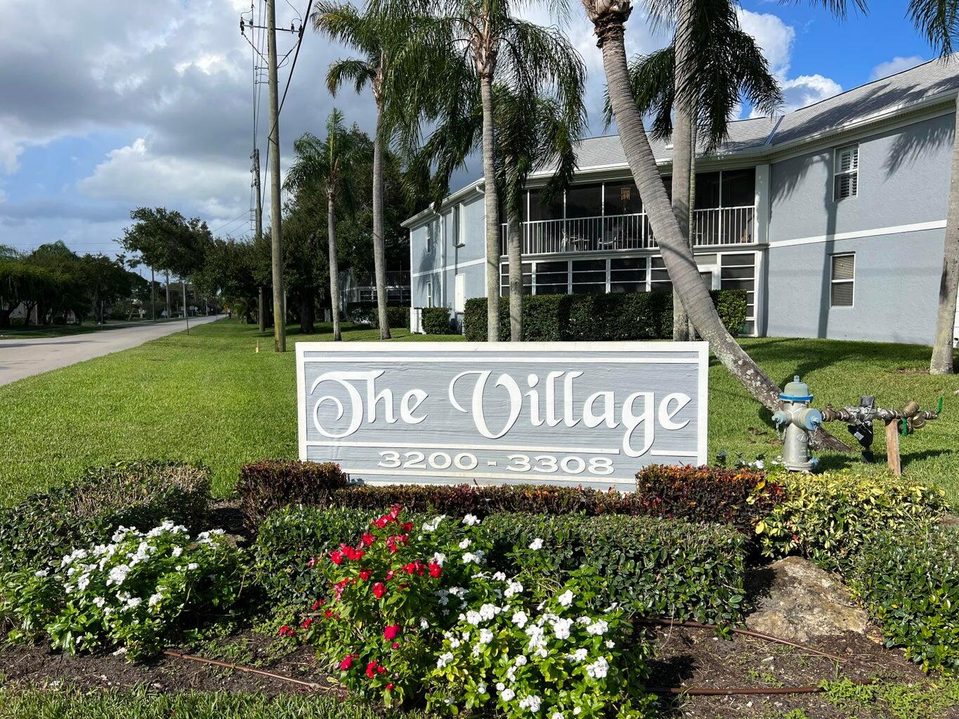 a view of sign board with yard and lake view