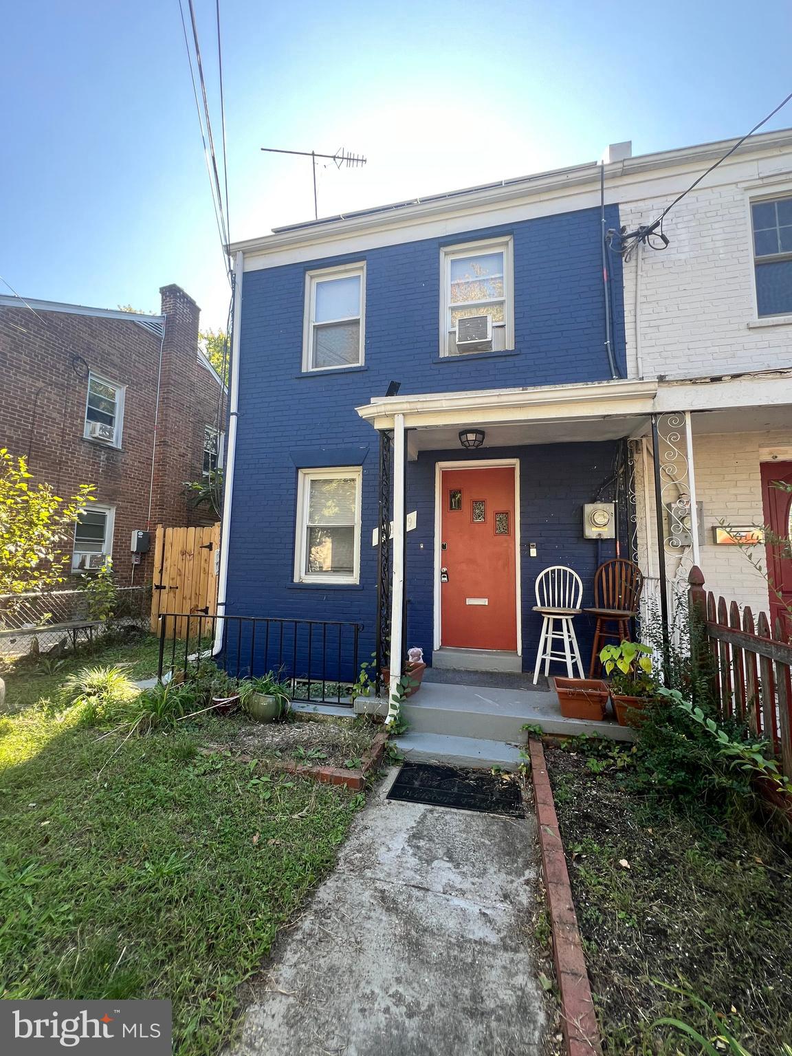 a view of a brick house with a yard